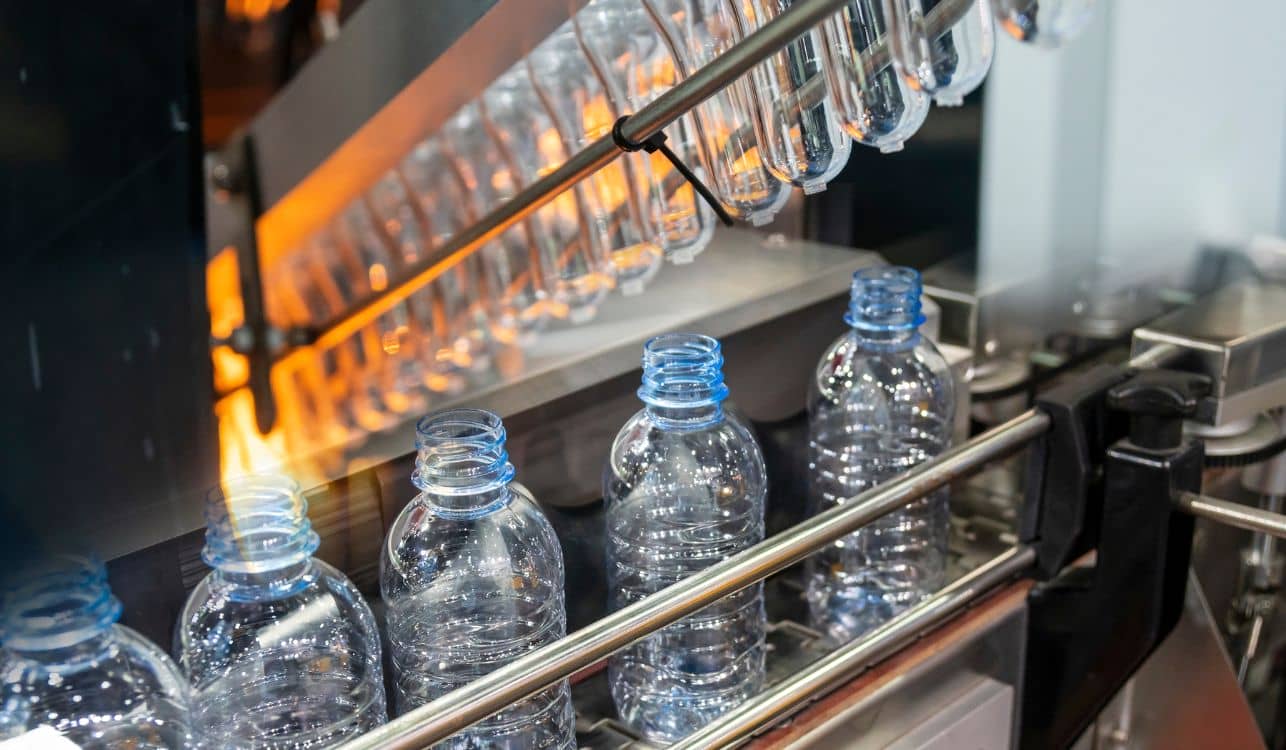 Plastic bottles being created.